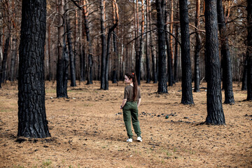 Destruction in the eyes of future generations. Sadness and pain. Black forest after the fire. Destruction of nature and climate change