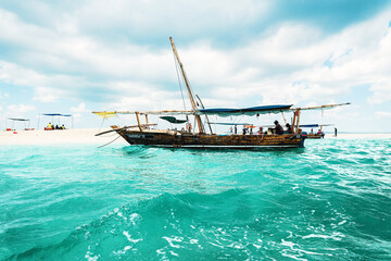 Boat near sand bank with tourists in Zanzibar