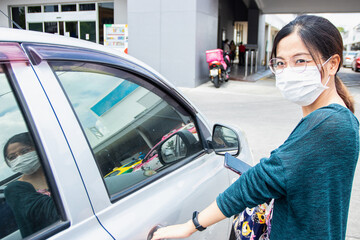 NONTHABURI, THAILAND - APRIL18, 2020: Beautiful Asean woman wearing the medical masks to travel outside.