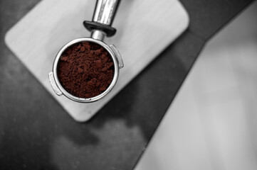 coffee powder on coffee tamper put on on cutting board