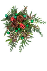 Christmas composition with green baubles & winter greenery with holly, mistletoe, ivy, pine cones & cedar cypress fir on white background. Xmas & New Year decorative display. Flat lay, top view, copy 