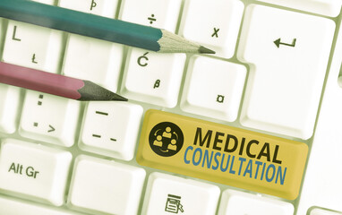 Conceptual hand writing showing Medical Consultation. Concept meaning act of seeking assistance from another physician Colored keyboard key with accessories arranged on empty copy space