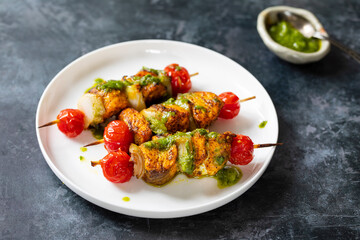 Spicy salmon skewers with parsley oil