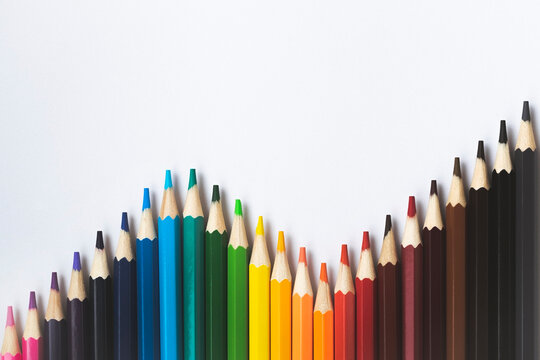 Pencils on a white background. A set of colored pencils. View from above. Stationery.
