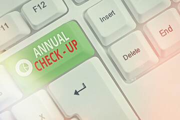 Handwriting text writing Annual Checkup. Conceptual photo yearly reproductive health visit with a health care provider Different colored keyboard key with accessories arranged on empty copy space