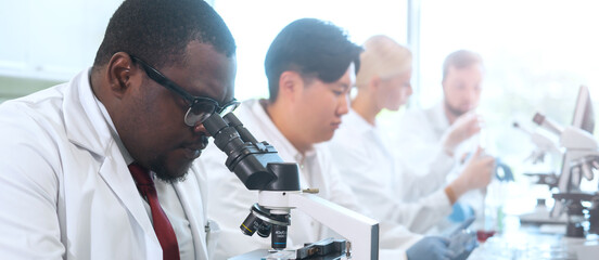 Scientist and students working in lab. Doctor teaching interns to make analyzing research....