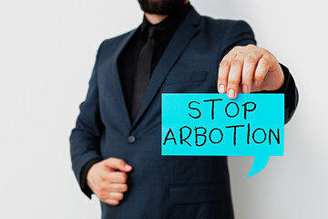 Writing note showing Stop Arbotion. Business concept for advocating against the practice of...