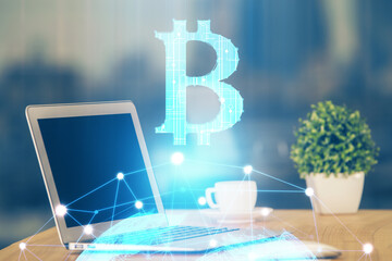 Multi exposure of blockchain theme hologram and table with computer background. Concept of bitcoin crypto currency.