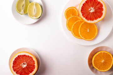 sliced citruses on white 