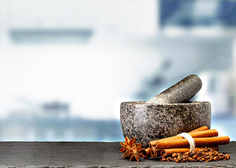granite mortar and spices on table in front of blurred kitchen