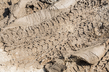 Wheel track on road muddy. Mud texture background.