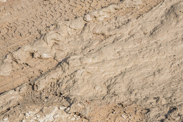 Wheel track on road muddy. Mud texture background.