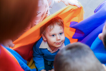 Fototapeta na wymiar little boy playing in a tent