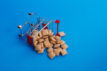 Dumped shopping basket with cookies on a blue background.