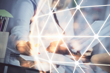 Social network theme hologram over hands taking notes background. Concept of global international people connect. Double exposure