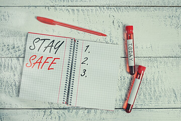 Conceptual hand writing showing Stay Safe. Concept meaning secure from threat of danger, harm or...