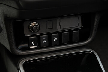 Close up of a charging in the car, cigarette lighter, aux, usb connectors. modern car interior.