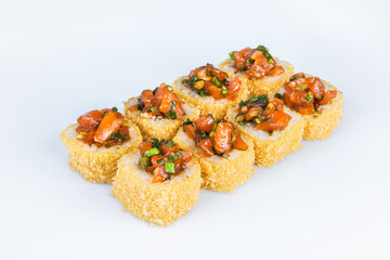 Japanese Volcano Roll with breading isolated on gray background. Asian Hot Roll pieces with marinated salon, green spring onion scallions. Food menu isolation.
