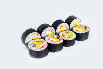 Japanese Futomaki Sushi Roll pieces isolated on gray background. Asian Maki roll with unagi eel, mango, avocado, flying fish roe (tobiko caviar) and Philadelphia chesse. 
