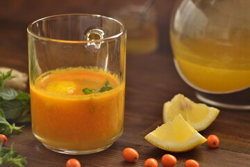 Sea buckthorn tea with lemon, honey and mint