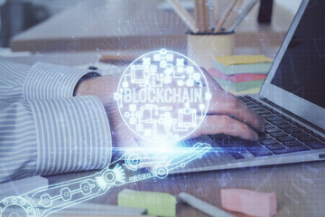 Blockchain theme hud with businessman working on computer on background. Concept of crypto chain. Double exposure.