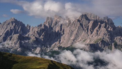 Unusual view of the Sesto Dolomites in Italy wrapped in clouds from top to bottom as seen from Carnic Peace Trail from Sillianer refuge to Obstansersee refuge on top of the Carnic Alps ridge, Austria.