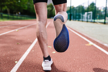 Sprinter fit man on running tracks at outdoor stadium