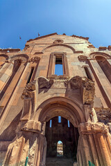 Vertical view of the main entrance gate of the cathedral in Ani ruins, Kars, Turkey. All the structures at Ani are constructed using the local volcanic basalt, a sort of tufa stone.