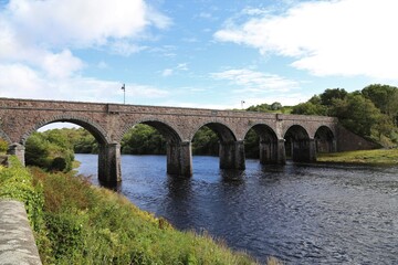 Fototapeta na wymiar The historic seven arches bridge spanning the Newport River flowing through County Mayo, Ireland.