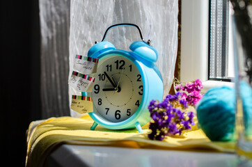 bright blue alarm clock on the windowsill