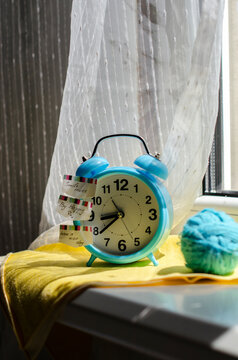 bright blue alarm clock on the windowsill
