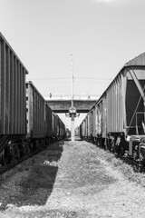 Black and white photo of railway carriages going into perspective
