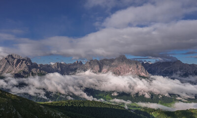 Unusual view of the Sesto Dolomites in Italy wrapped in clouds from top to bottom as seen from Carnic Peace Trail from Sillianer refuge to Obstansersee refuge on top of the Carnic Alps ridge, Austria.