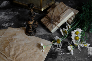 vintage clock on the table with books 
