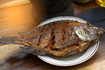 Nile Tilapia fish after fried on white plate