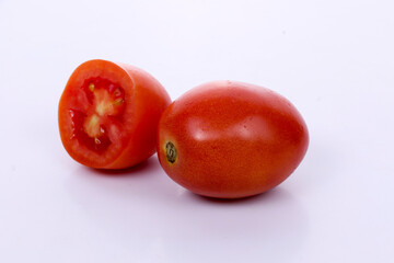 Red tomatoes with cut isolated on dark background