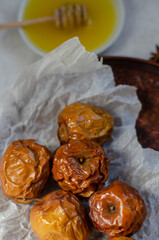 baked apples with honey on a clay plate