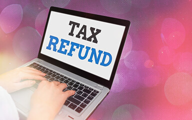 Writing note showing Tax Refund. Business concept for excess payment of paid taxes returned to...