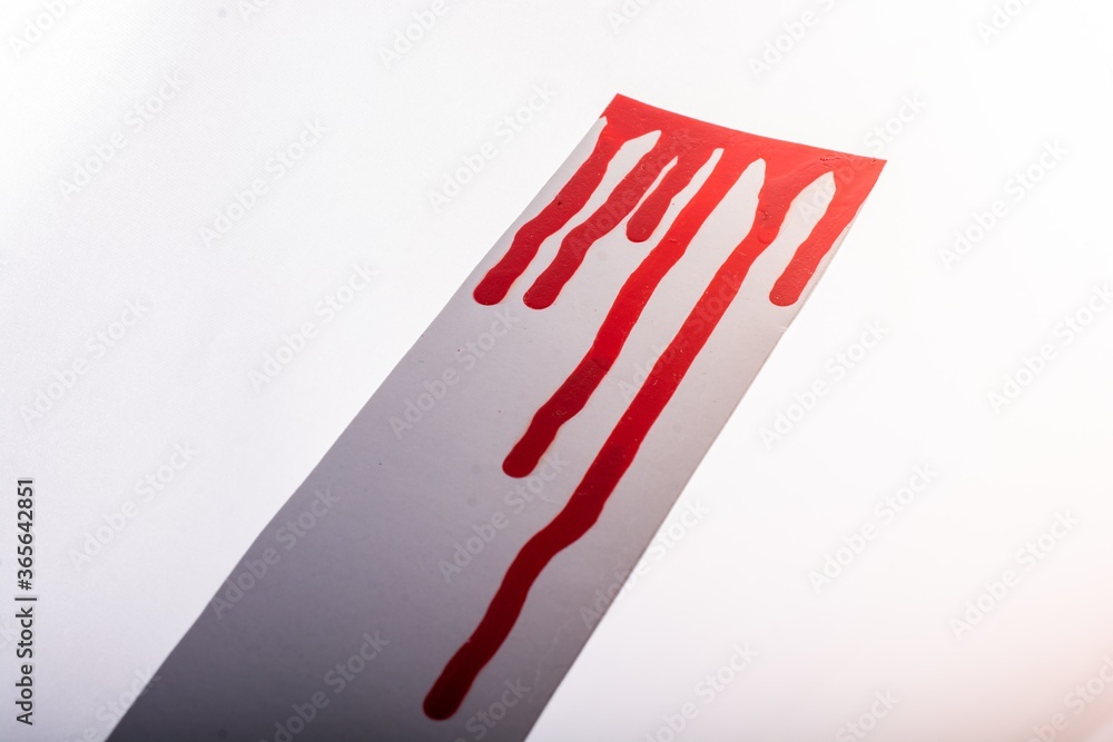 Poster closeup shot of a gray texture with red paint on it isolated on a white background
