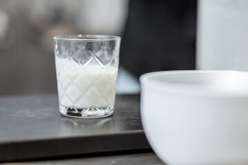 Chef pouring milk into the glass, close-up