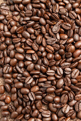 Roasted coffee beans on sackcloth.