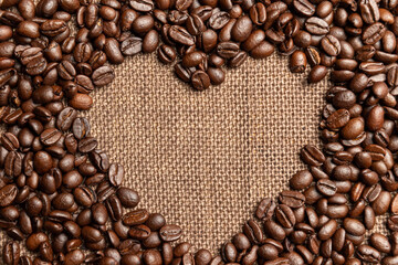 Roasted coffee beans on sackcloth.