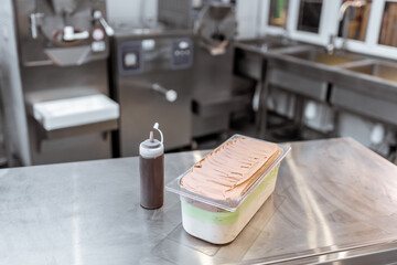 Ice cream with chocolate on the table in the kitchen of a small ice cream factory