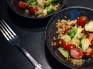 Salad with bulgur and vegetables, tomatoes and Brussels sprouts.