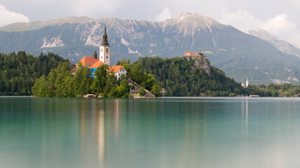 Fototapeta na wymiar Bled church and lake on a cloudy day with long exposure techniques