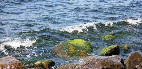 Waves crashing stones on the beach