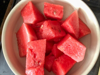 A bowl of pieces of watermelon cut into chunks