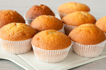 Delicious cupcakes close-up on a wooden board. Selective focus. The finished baked goods were taken...