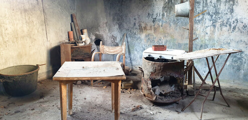 An old, abandoned room with old furniture. Poverty.