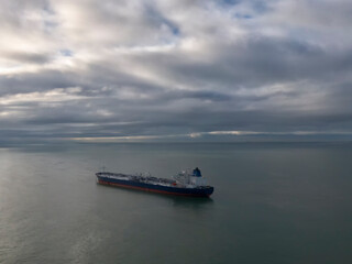 drone photo of a suezmax tanker at anchor in cloudy weather